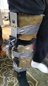 This is a photo of the user wearing the leg brace. The fiberglass works as a brace for their leg while the aluminum parts go down the leg and act as housing for the motors. They also acts as arms to drive movement of the leg as the motors turn. 